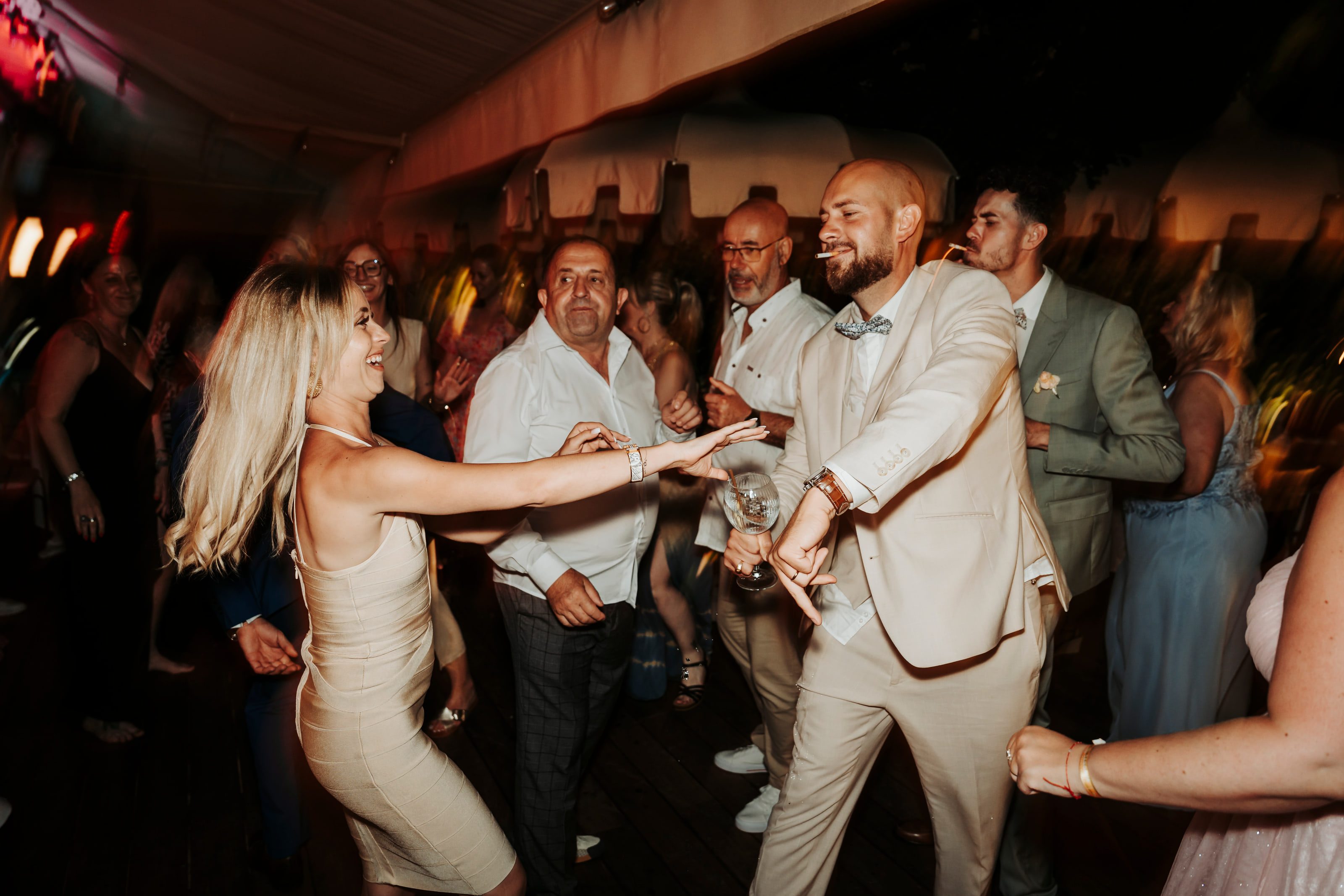Guests dancing closely at an evening reception.